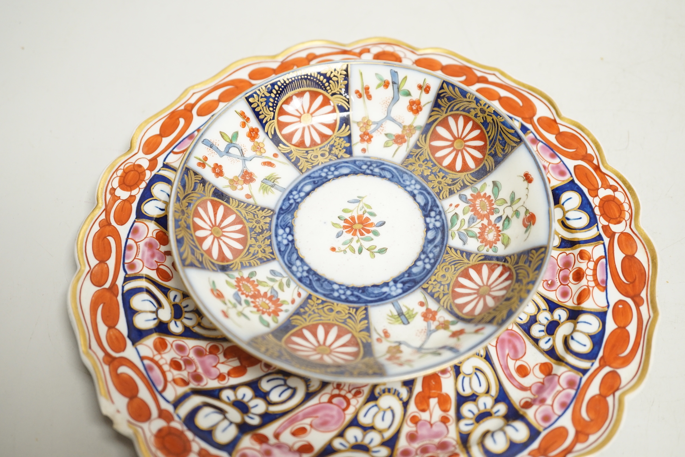 A Worcester kakiemon style scale blue trio, c.1770, a Worcester Queen Charlotte’s pattern plate, 19.5 cm and a Samson saucer in Worcester style